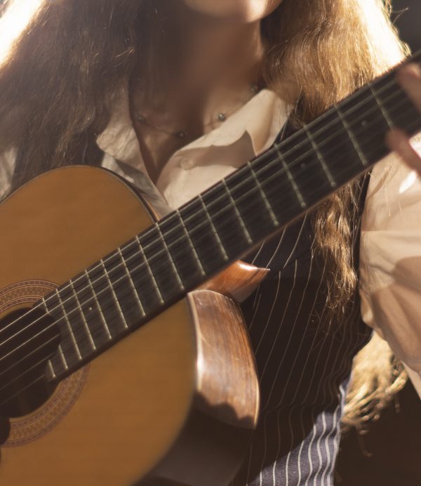 Close up of guitar fingering and plucking.