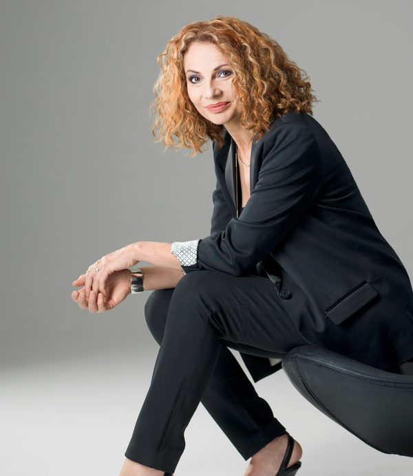Joanna MacGregor sat at a chair looking to camera.