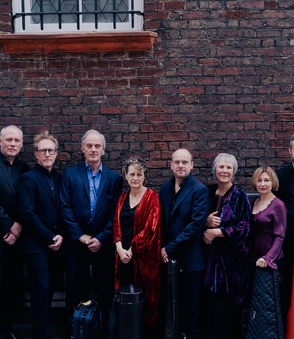 The Nash ensemble in front of a brick wall.