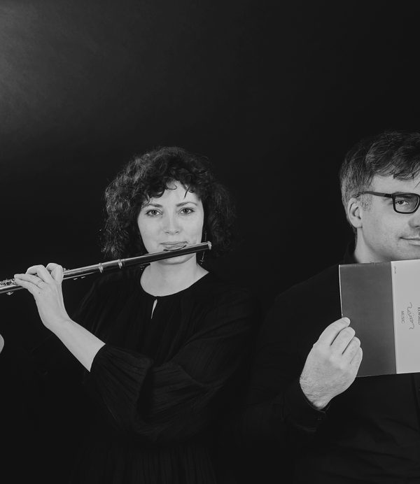Anna Kondrashina playing flute and Pavel Timofeyevsky holing a DEbussy programme