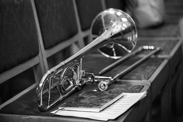 A trombone on top of sheet music.