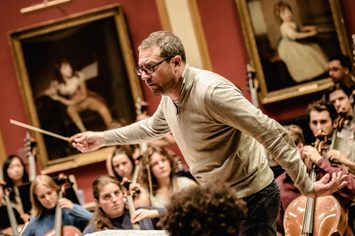An image of John Wilson conducting the Academy Symphony Orchestra