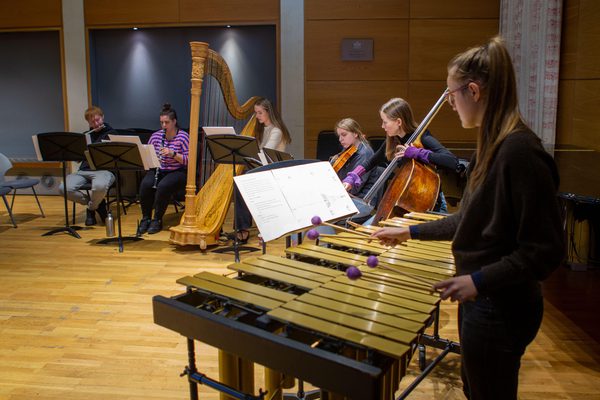 Academy students rehearsing with Riot Ensemble members.