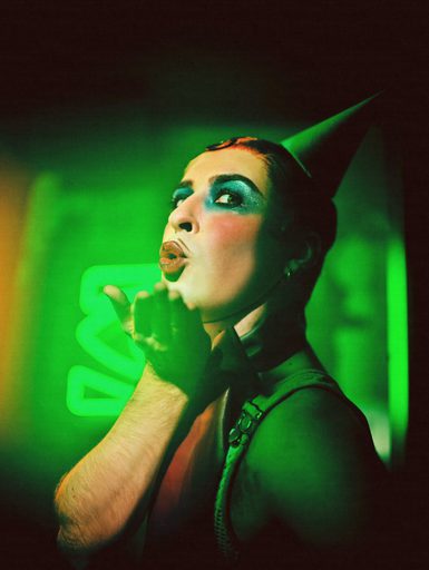 Rob Madge in costume as Emcee in Cabaret blowing a kiss to the camera
