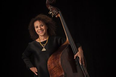 CHI CHI NWANOKU HOLDS HER INSTRUMENT AND SMILES