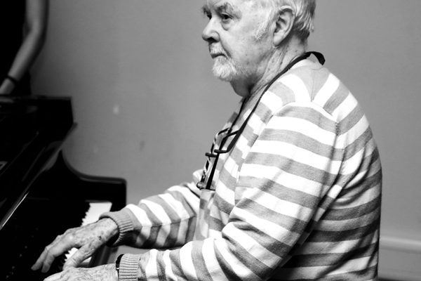 George Hall plays the piano.
