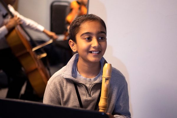 Young flautist at a music stand