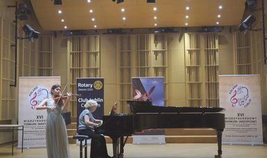 A violinist accompanied by a pianist