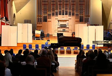 Young pianist performing on the Duke's Hall stage