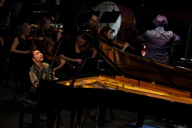 Junyan Chen performing on a grand piano in the Final of the Leeds International Piano Competition with the Liverpool Philharmonic Orchestra