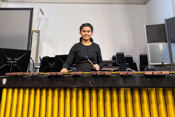 Prapti debsarker stands at a xylophone.