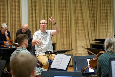 A musician conducts an ensemble