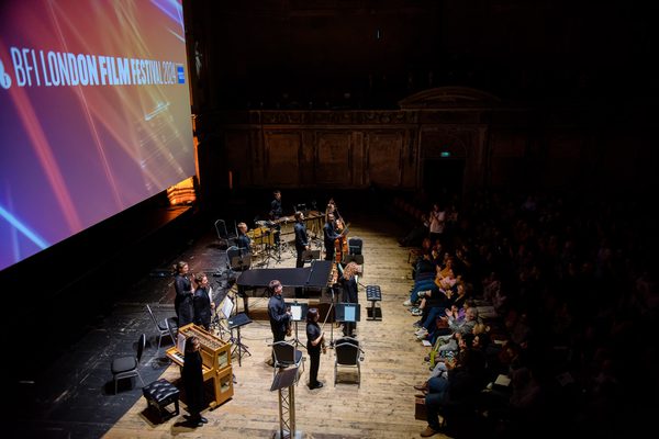 Academy musicians on the stage of Alexandra Palace's Theatre, receiving applause
