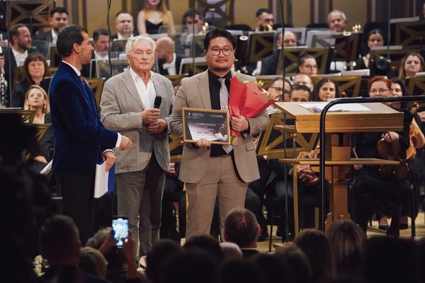 Shin Kim receiving a certificate at the 19th George Enescu International Competition