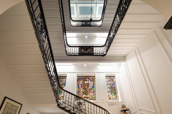 An ornate stairwell with white masonry.