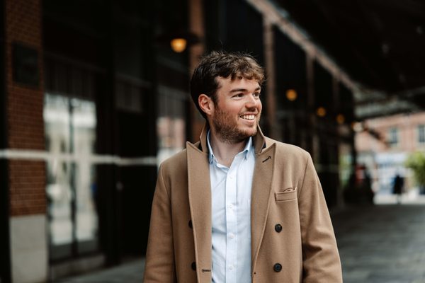 Timothy Ridout walking and smiling at something out of frame.