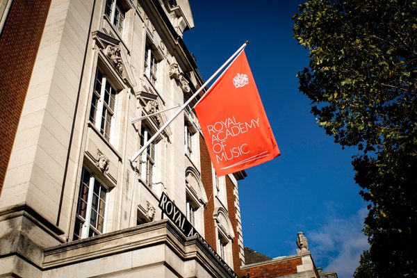 The Academy flag against a clear blue sky.