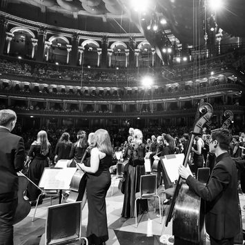 Performers stand on stage during applause.