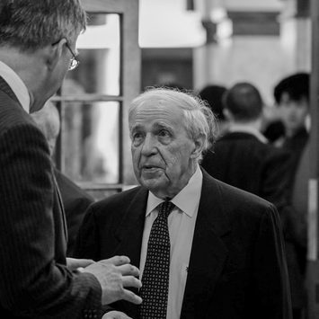 Two people in conversation, from over the shoulder.