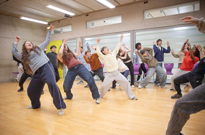A group of performers in a dance class.