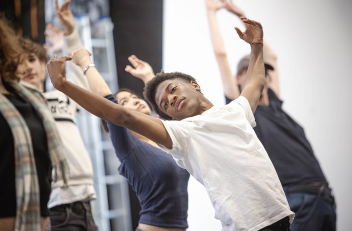A young performer dances with their eyes closed.