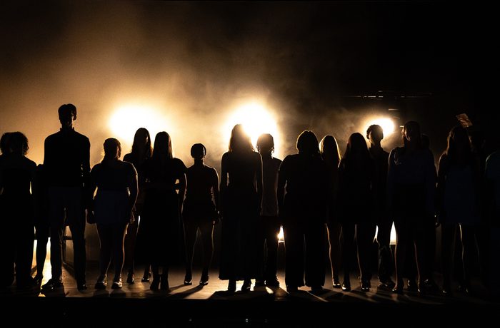A young musical theatre ensemble on stage.