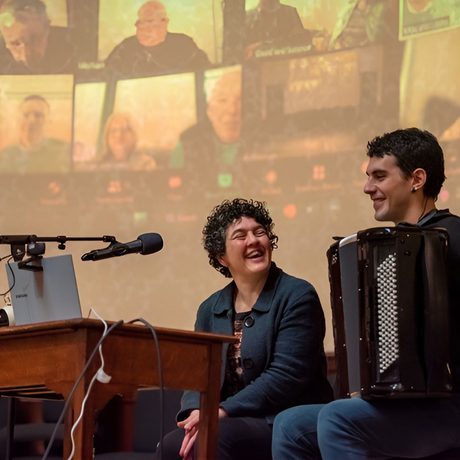 Musicians talk on stage.