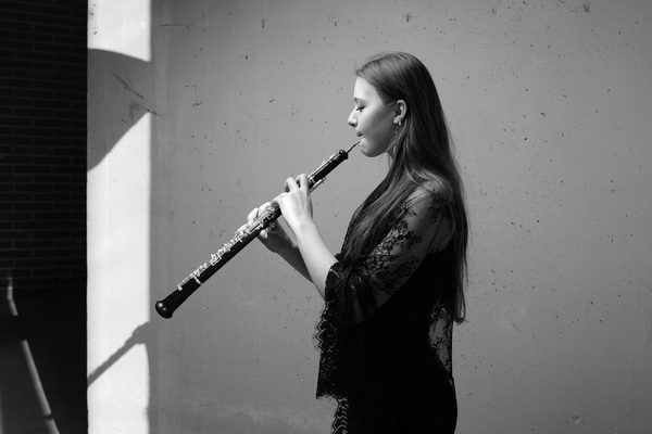 A student plays a clarinet (black and white).