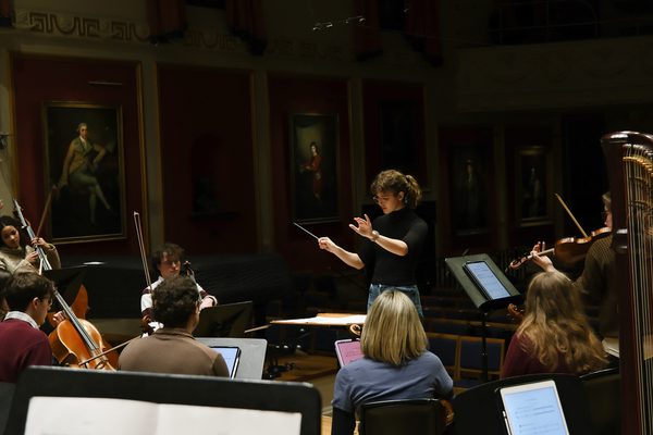 A conductor and musicians.