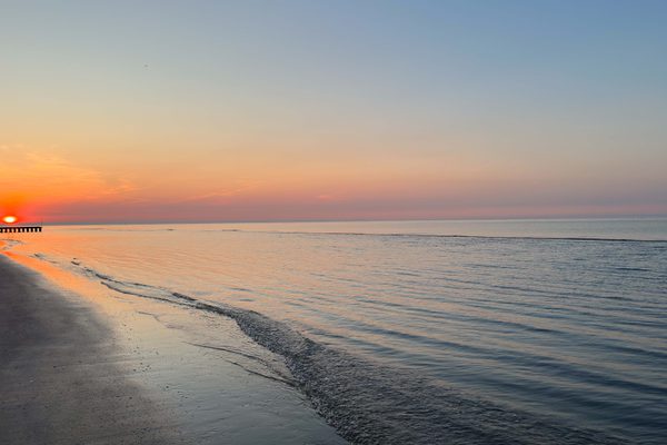 Side view of a coastline at sunset.
