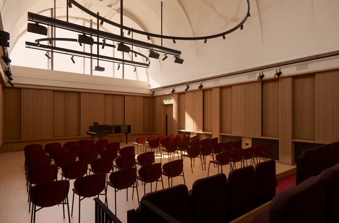 The performance space and seating area of an intimate recital hall.