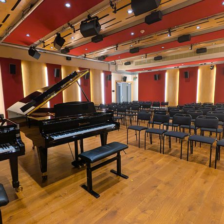A concert room set up with two pianos for a recital.
