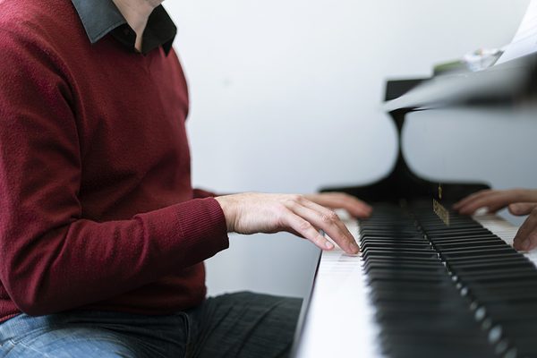 Close up of hands on a piano keyboard.
