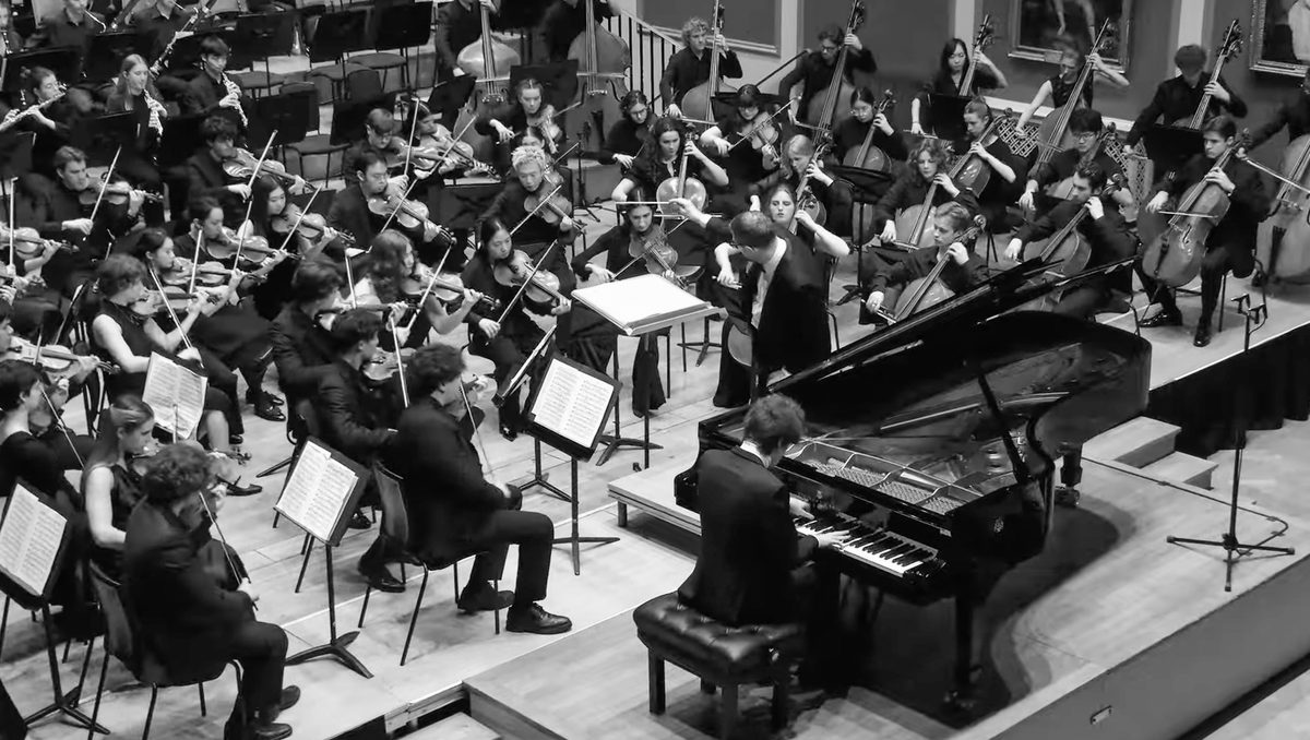 The Academy Symphony Orchestra and a pianist.