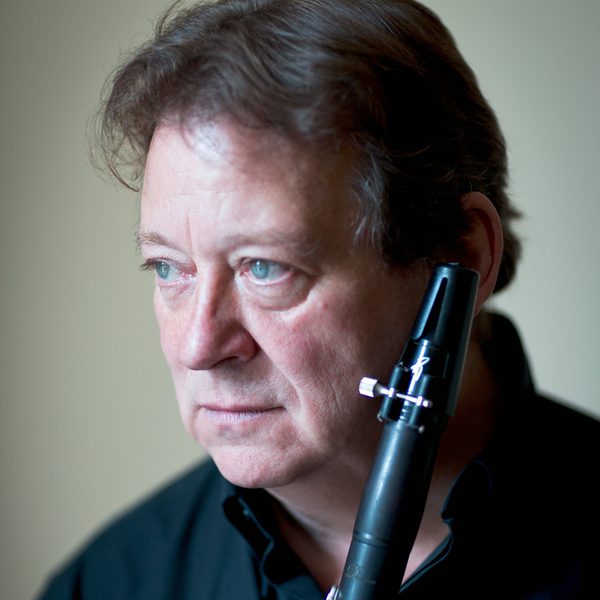 Profile of Andrew Marriner holding a Clarinet.