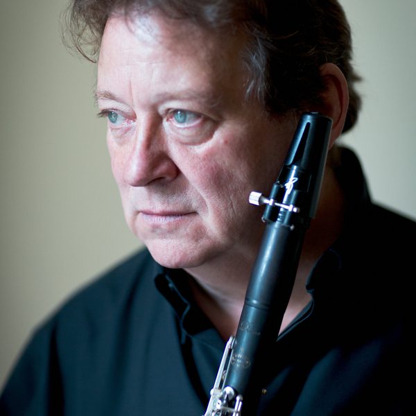 Profile of Andrew Marriner holding a Clarinet