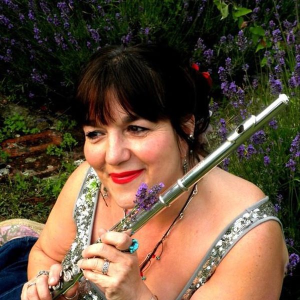 Anna Noakes smiling, holding a flute.