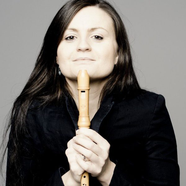 Anna Stegmann looks to camera, holding a baroque recorder.