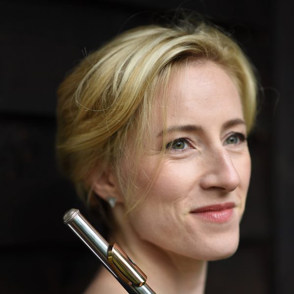 Side portrait of Anna Wolstenholme holding a flute.