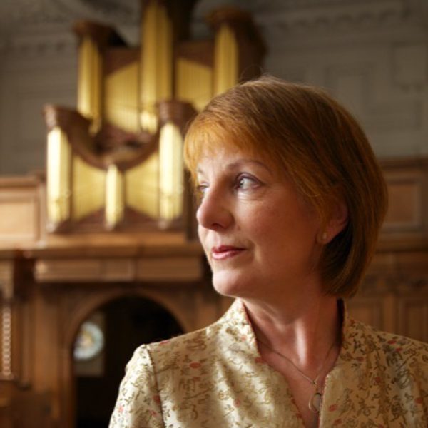 Anne Page looks thoughtfully to the side, backed by a fireplace