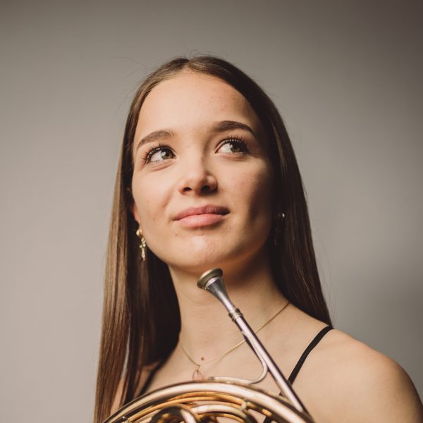 Portrait of Annemarie Federle holding a horn.
