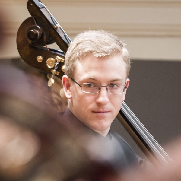Portrait of Billy Cole in concert.