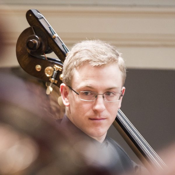 Portrait of Billy Cole in concert.