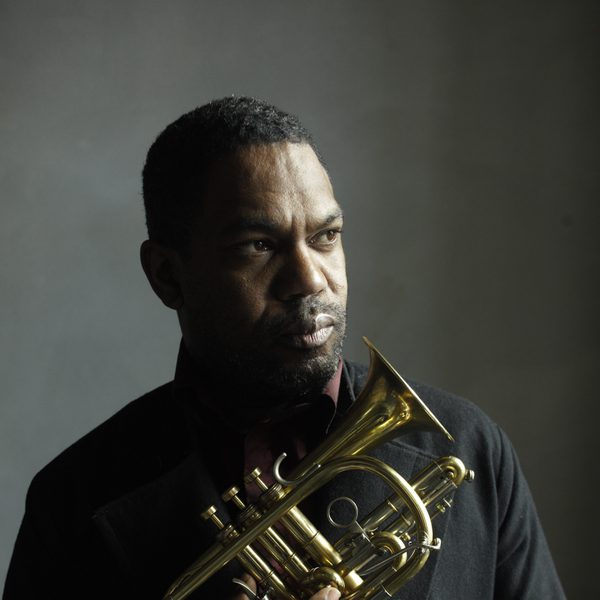 Byron Wallen holds a trumpet indoors.