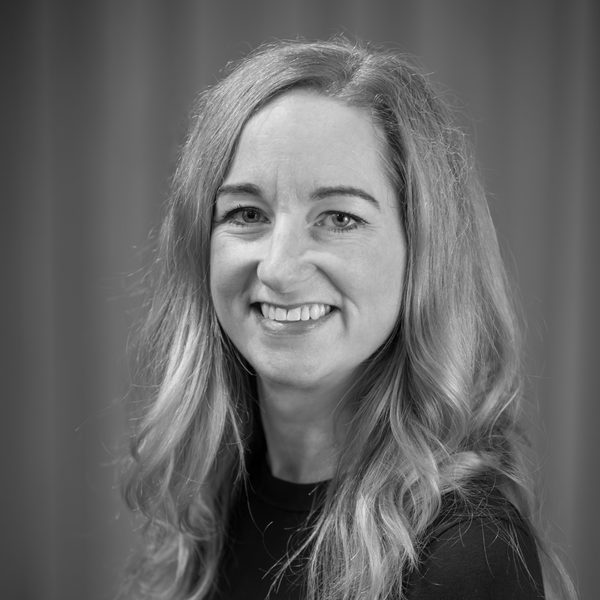 Portrait of Catherine Jury smiling to camera (black and white)