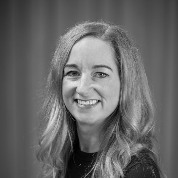 Portrait of Catherine Jury smiling to camera (black and white).