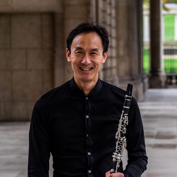 Chi-Yu Mo smiles for camera, holding a clarinet.