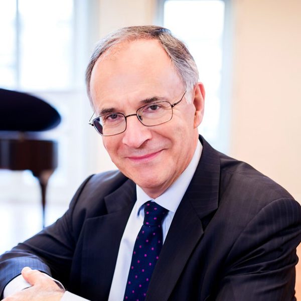 Clive Gillinson smiles to camera.