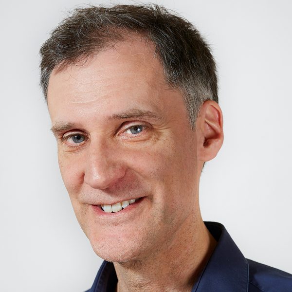 Portrait of Darius Battiwalla smiling to camera.
