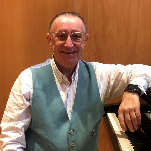 Dave Whitson sits at a keyboard, smiling for camera